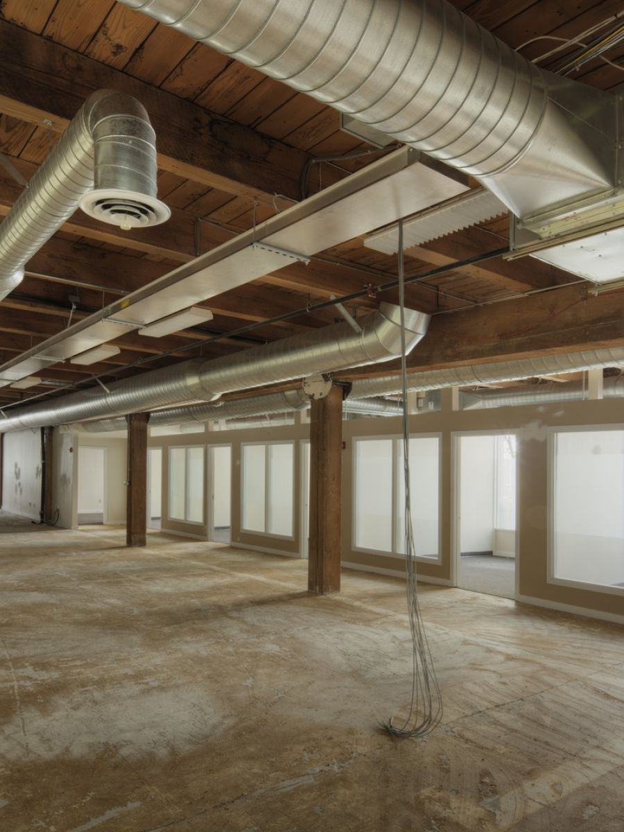 Commercial Renovations Open Space With Exposed Ducts And Windows
