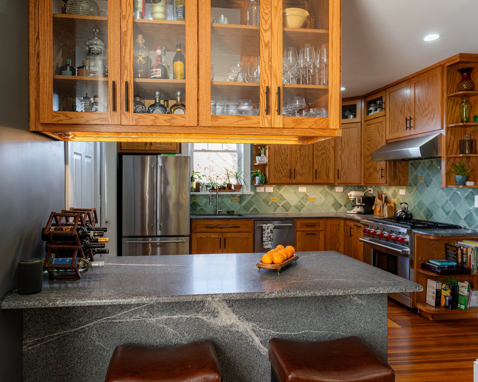 Kitchen With Wooden Cabinets And Gray Countertop Featuring Oranges