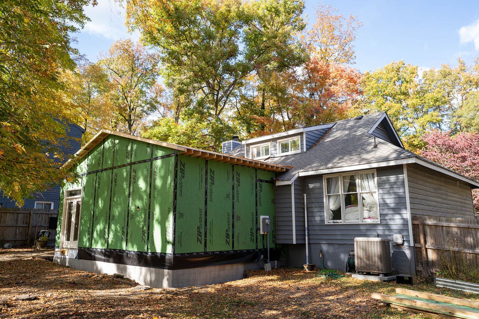 New Addition Construction Next To House In Autumn Leaves